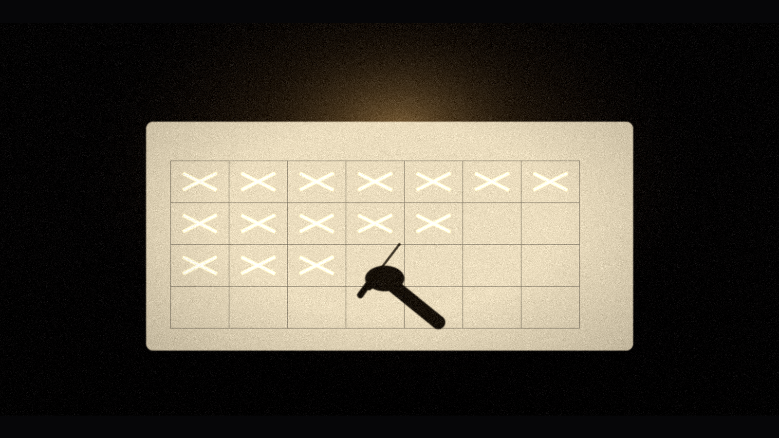A hand marking an X on a habit tracker, building consistency habits when life is hard
